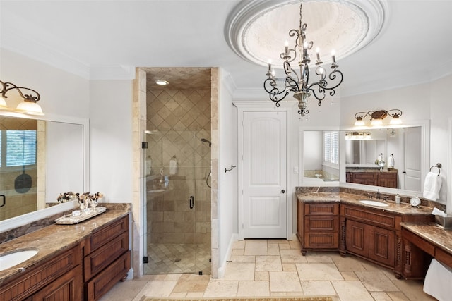 full bath featuring a sink, two vanities, a shower stall, and crown molding