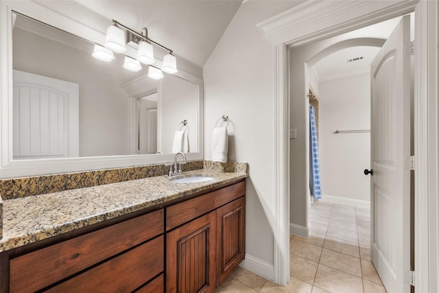 bathroom with visible vents, vanity, a chandelier, baseboards, and tile patterned floors