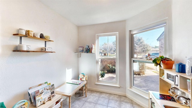 home office with light tile patterned floors and baseboards