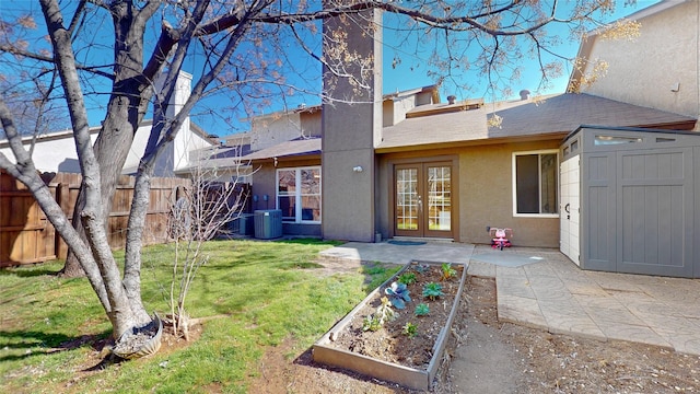 back of property with a patio, fence, french doors, a lawn, and a vegetable garden