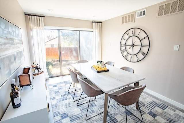 dining space with baseboards and visible vents