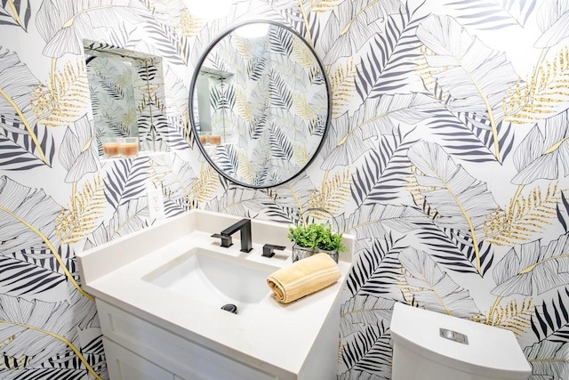 bathroom with toilet and vanity