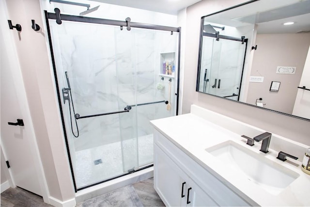 full bathroom featuring recessed lighting, a marble finish shower, visible vents, and vanity