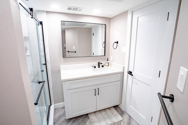 bathroom with vanity, wood finished floors, and visible vents