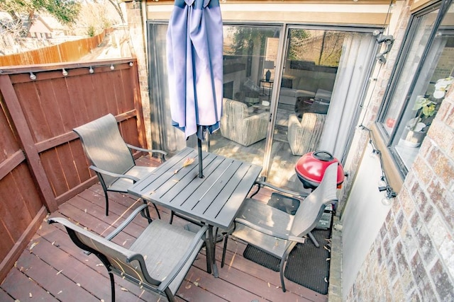 wooden terrace with outdoor dining space