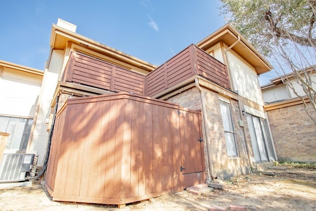 view of side of home featuring central AC unit