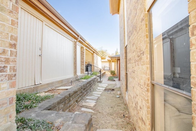 view of side of home with brick siding