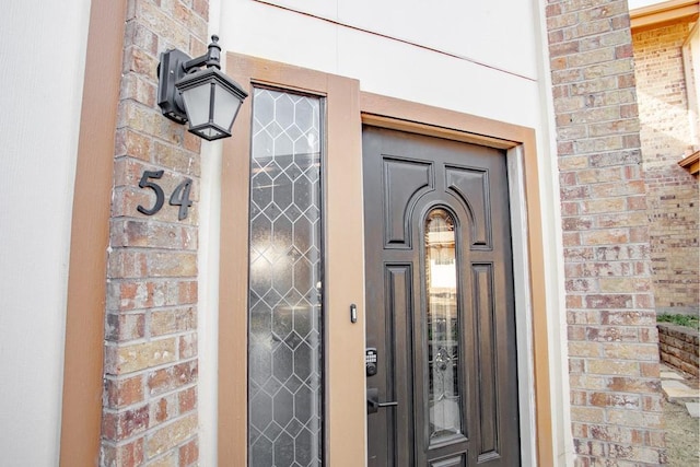 entrance to property with brick siding