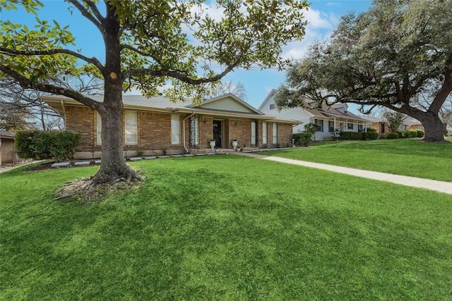 single story home with brick siding and a front lawn