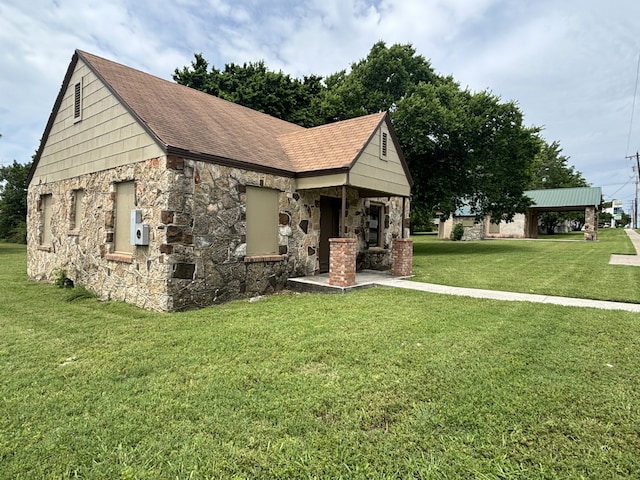 view of front of property with stone siding and a front yard