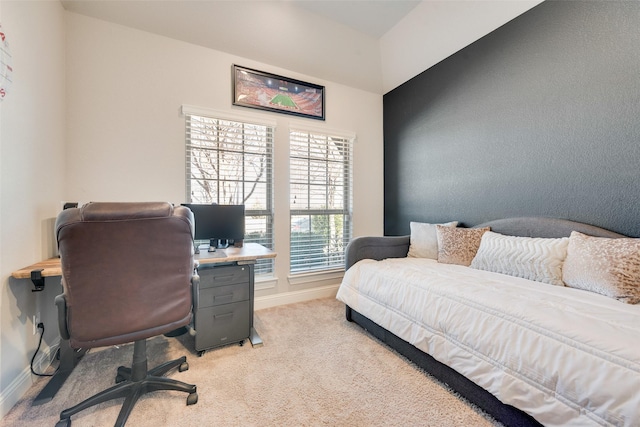 bedroom featuring baseboards and light colored carpet