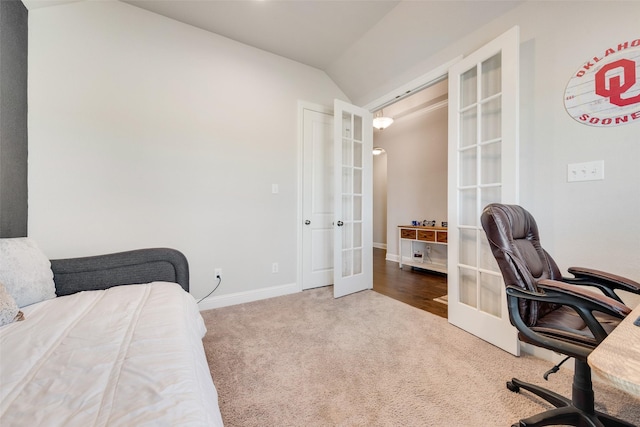 bedroom with lofted ceiling, french doors, carpet flooring, and baseboards