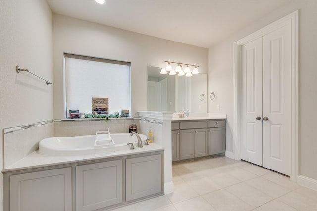 full bath with a garden tub, vanity, and tile patterned floors