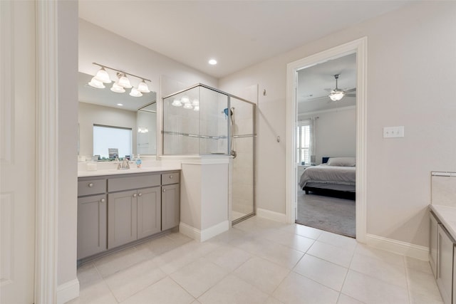 full bath with a stall shower, tile patterned flooring, ceiling fan, and vanity