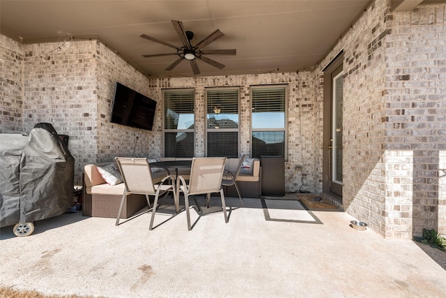 view of patio / terrace with outdoor dining area, a grill, and a ceiling fan