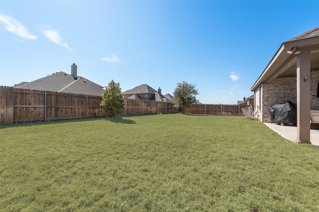 view of yard with a fenced backyard