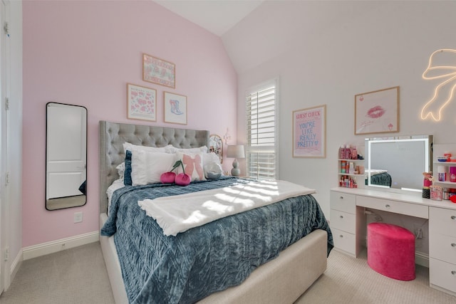 carpeted bedroom with vaulted ceiling and baseboards