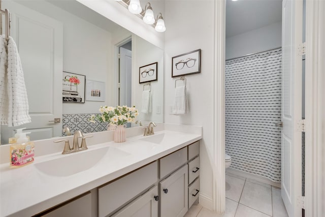 full bath with toilet, tile patterned flooring, double vanity, and a sink