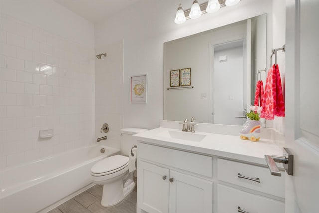 full bathroom featuring toilet, shower / bath combination, wood finished floors, and vanity