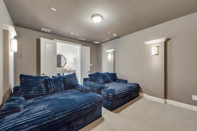 carpeted cinema room featuring visible vents, a textured ceiling, and baseboards