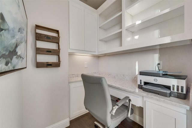 home office with baseboards, dark wood-type flooring, and built in study area