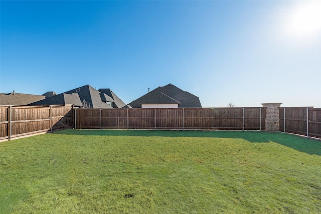 view of yard with a fenced backyard