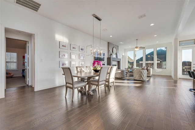 dining space featuring visible vents, plenty of natural light, and wood finished floors