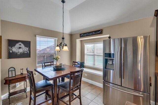 dining room featuring lofted ceiling, light tile patterned floors, and baseboards