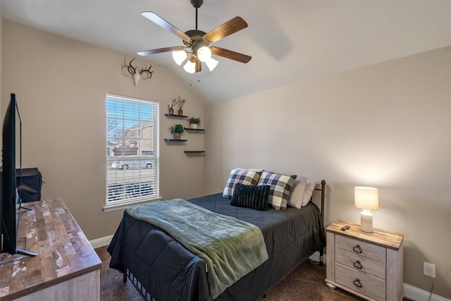 bedroom with lofted ceiling, dark colored carpet, ceiling fan, and baseboards