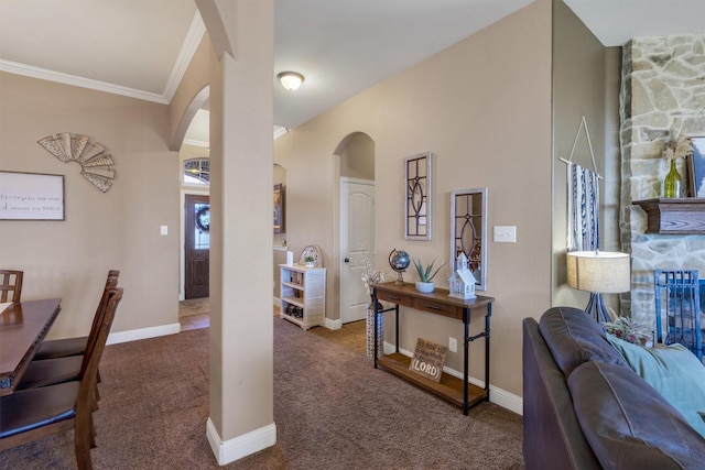 interior space with arched walkways, baseboards, carpet flooring, and crown molding