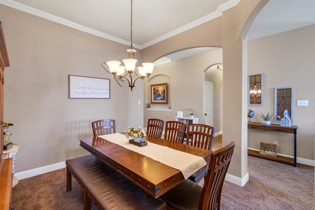 carpeted dining space with ornamental molding, arched walkways, a notable chandelier, and baseboards