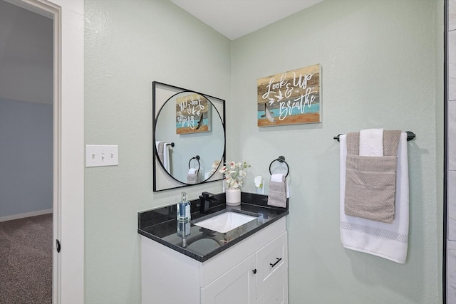 bathroom featuring vanity and baseboards