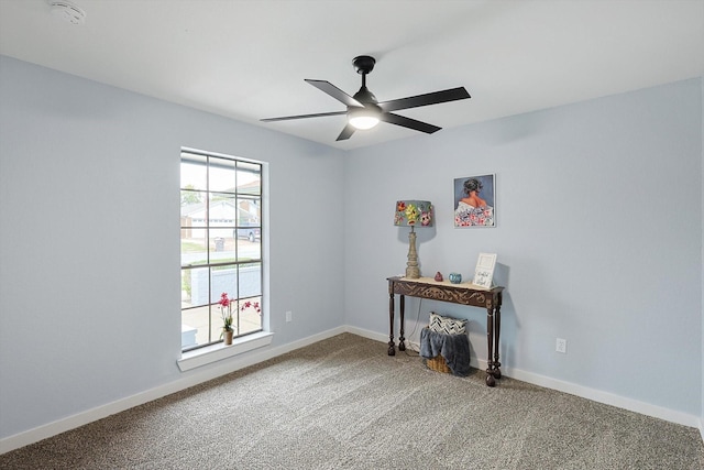 unfurnished room featuring ceiling fan, baseboards, and carpet flooring