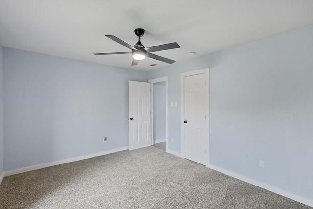 unfurnished bedroom featuring carpet, baseboards, and ceiling fan