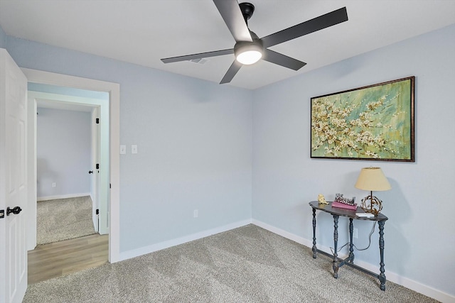 unfurnished room with a ceiling fan, carpet, and baseboards