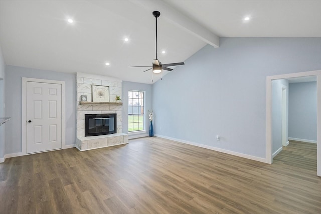 unfurnished living room featuring vaulted ceiling with beams, a fireplace, baseboards, and wood finished floors