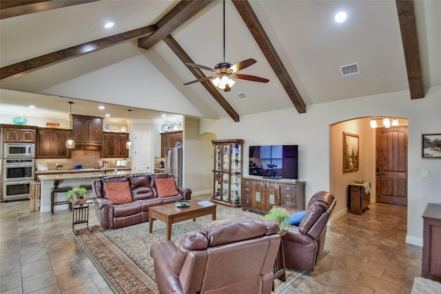 living room with high vaulted ceiling, visible vents, arched walkways, and beam ceiling