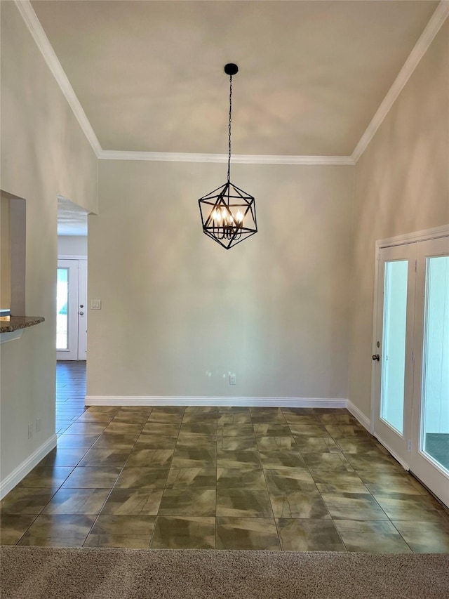 spare room featuring a towering ceiling, baseboards, a chandelier, and crown molding