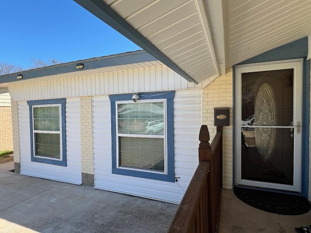 doorway to property with brick siding