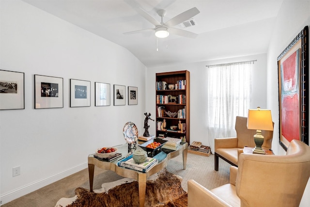 carpeted office featuring a ceiling fan, visible vents, vaulted ceiling, and baseboards