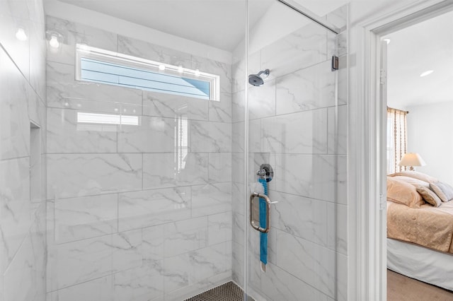 ensuite bathroom featuring a marble finish shower, a wealth of natural light, and ensuite bathroom