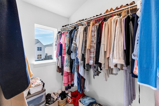 walk in closet featuring vaulted ceiling