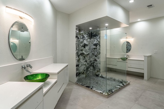 bathroom with recessed lighting, a sink, two vanities, visible vents, and a shower stall