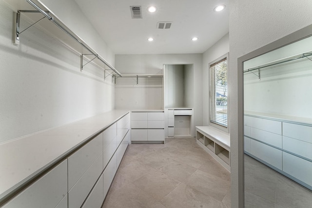 spacious closet featuring visible vents