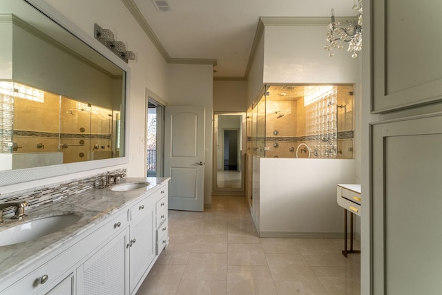 full bathroom with a tile shower, a sink, and crown molding