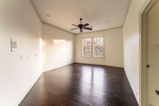 empty room featuring baseboards, visible vents, dark wood finished floors, a ceiling fan, and ornamental molding