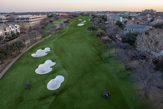 aerial view at dusk featuring golf course view