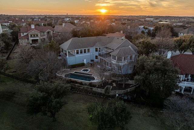 aerial view at dusk featuring a residential view