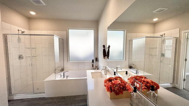 full bathroom featuring a wealth of natural light, a stall shower, visible vents, and a garden tub