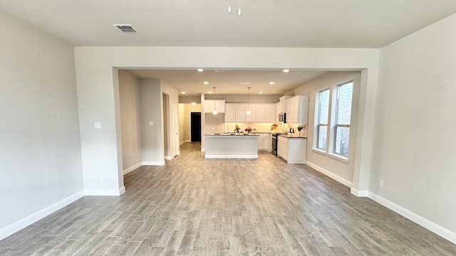 1908 Brindle St, Northlake, TX 76247 - unfurnished living room with ceiling fan, a tile fireplace, baseboards, and light wood-style floors